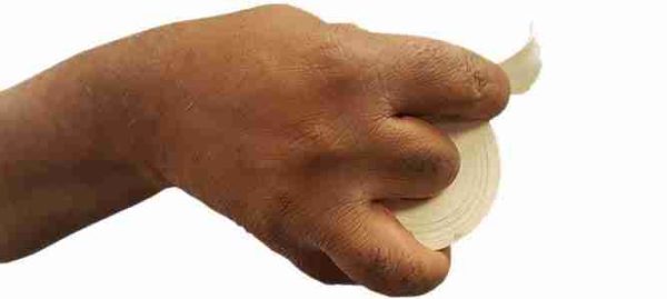 Step 2 of how to rip athletic tape - piece of tape extending from the roll and held between the thumb and forefinger.
